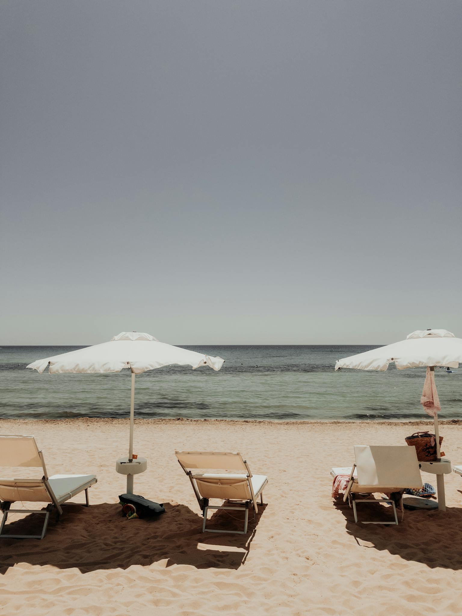 Sunbeds and Beach Umbrellas on Sunlit Beach